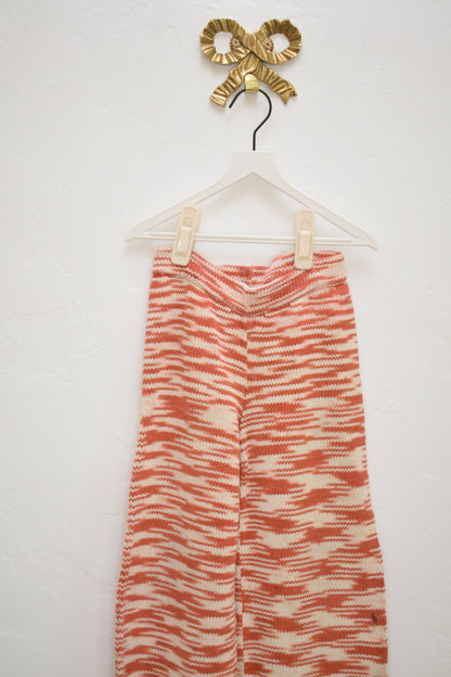 Misha & Puff red and cream marl knit kids pants, wide leg with elastic waist, size 4–5, on hanger against neutral wall.