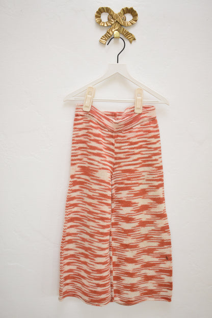 Misha & Puff red and cream marl knit kids pants, wide leg with elastic waist, size 4–5, on hanger against neutral wall.