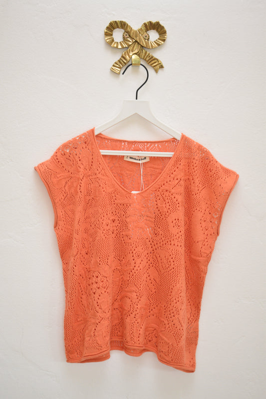 Misha & Puff coral openwork knit cap-sleeve top with V-neck, size 8–9, on hanger against neutral wall.