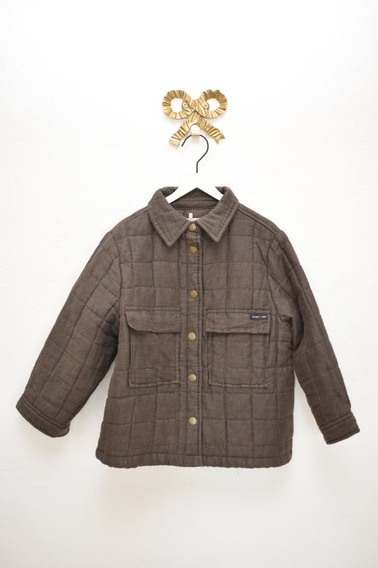 Rylee & Cru cocoa brown quilted coat with snap buttons, size 4–5 years, hanging on a white hanger against a neutral wall