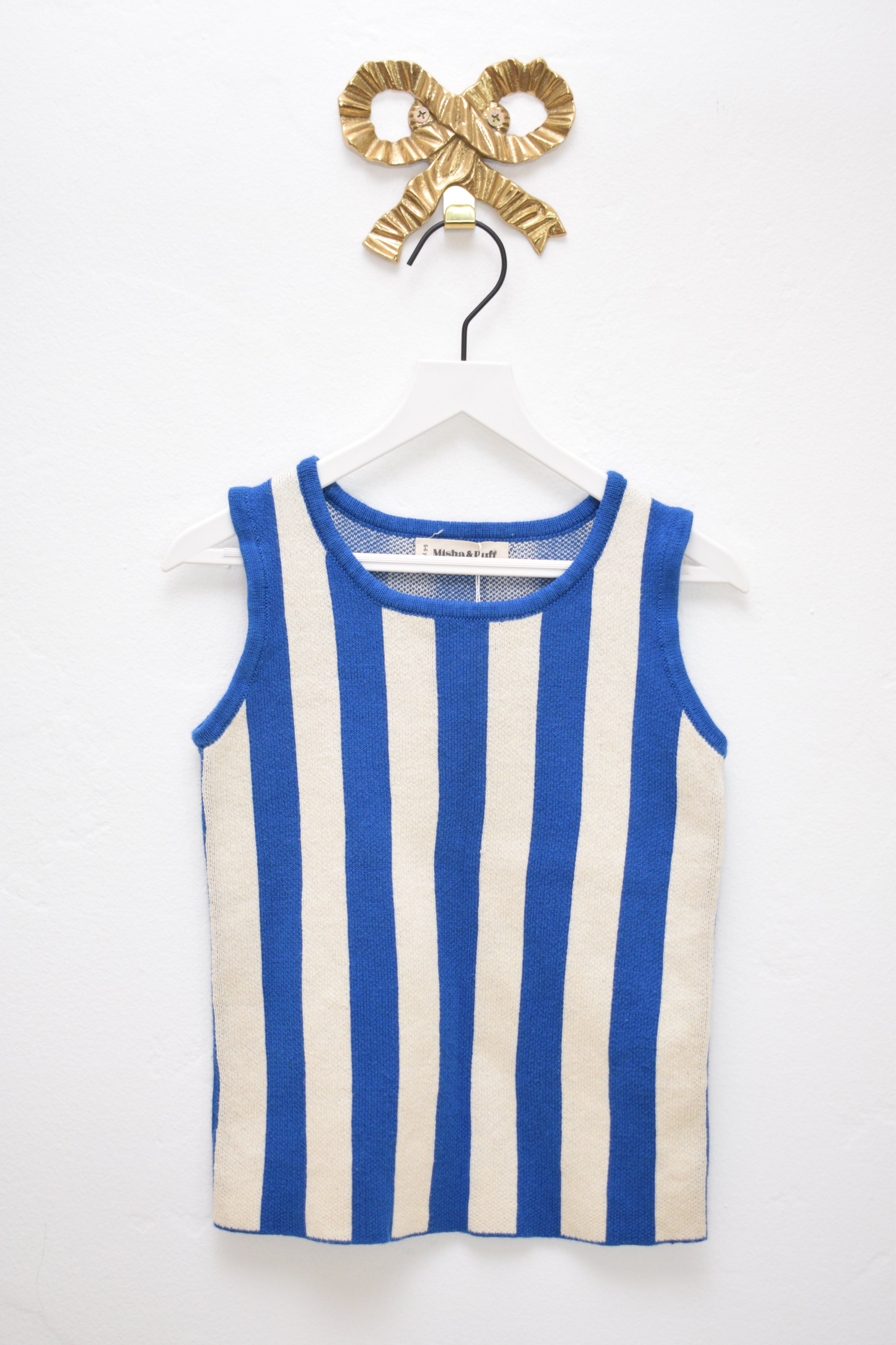 Misha & Puff striped knit tank and matching pull-on bottoms, size 5–6 years, in cream with contrast vertical stripes, hanging on a white hanger against a neutral wall.
